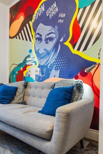 a couch in front of a wall with a mural at 44 North in Londonderry County Borough