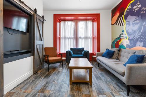 a living room with a couch and a flat screen tv at 44 North in Londonderry County Borough