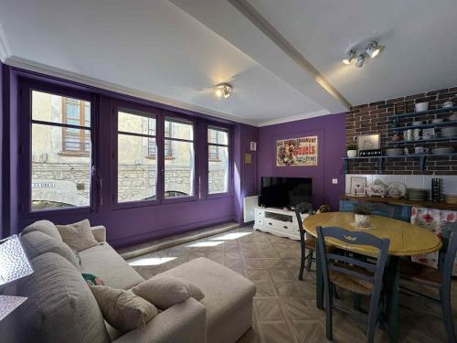 a living room with a couch and a table at Appartement cozy style Friends in Nîmes