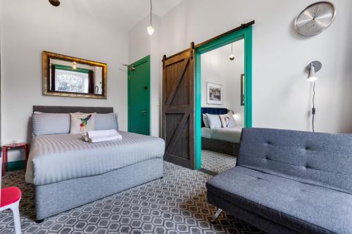 a living room with a couch and a bed and a door at 44 North in Londonderry County Borough