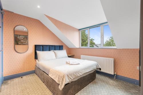 a bedroom with a bed with an orange wall at 44 North in Londonderry County Borough