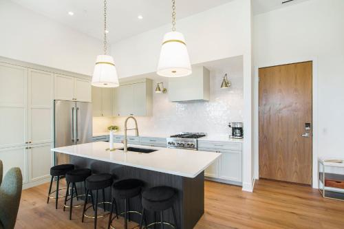 a kitchen with a large island with bar stools at Holland Loft in Holland