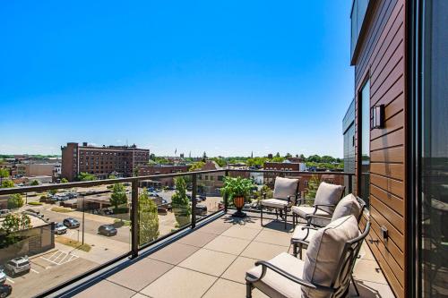 a balcony with chairs and a view of a city at Holland Loft in Holland