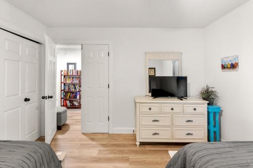 a bedroom with a dresser with a television on it at Inspect2Sea in Duck