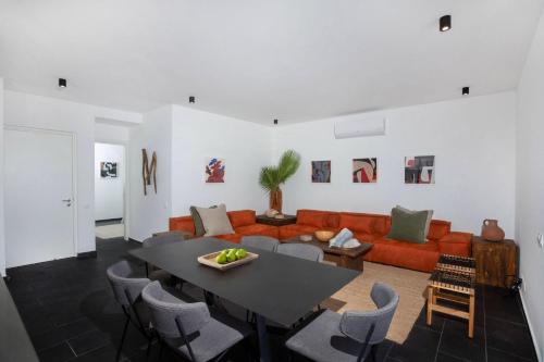 a living room with a couch and a table at Bridge House 201 - 3BR Penthouse in Limassol