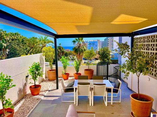 a balcony with a table and chairs and plants at Bridge House 201 - 3BR Penthouse in Limassol