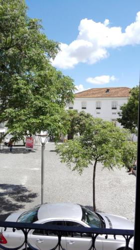 a car parked in a parking lot with a tree at Casa Resende- Parking included in Évora