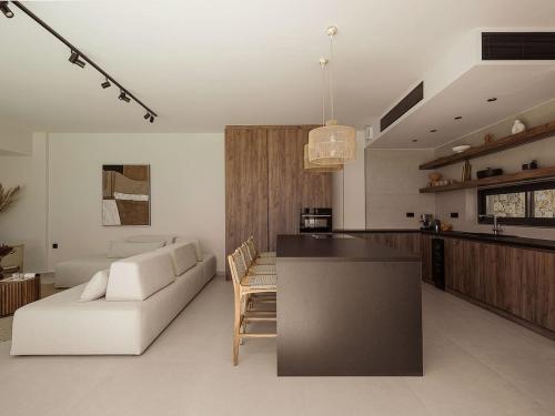 a kitchen and living room with a couch and a table at Villa Yoma- Luxury Villa with Heated Pool in Epáno Kefalás