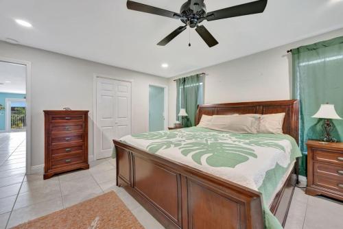 a bedroom with a bed and a ceiling fan at Sunny Waterfront Key Colony 3BR 3BA Villa w Dock in Key Colony Beach