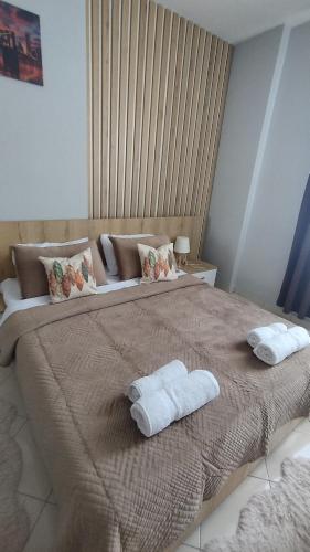 a bedroom with a large bed with towels on it at The Guest Apartment 2025 in Fier