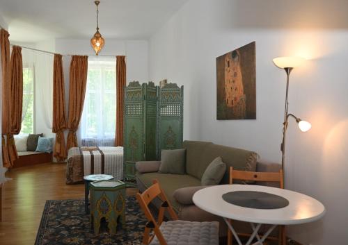 a living room with a couch and a table at Leier apartments in Piešťany