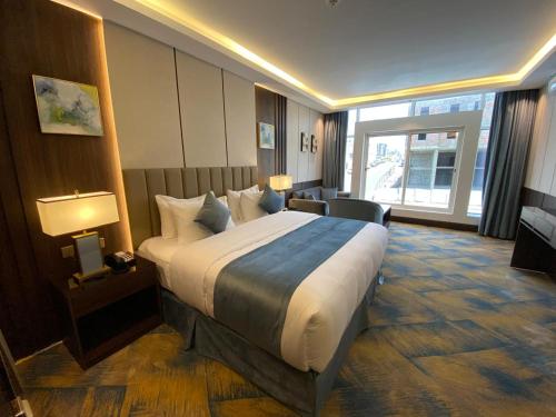 a bedroom with a large bed in a hotel room at فندق امان أبها - المحالة in Abha