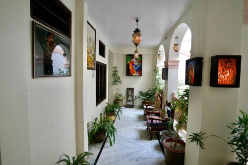 a hallway with potted plants in a building at Kanhaia Haveli in Pushkar