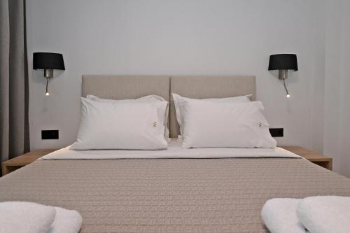 a bedroom with a bed with white pillows at Agios Nikolaos Villas in Ayios Nikolaos Sithonia