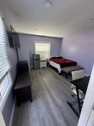 a bedroom with a bed and a desk and a window at Awesome deal! Room with private bathroom close to Kia Forum, Sofi Stadium and LAX airport in Inglewood
