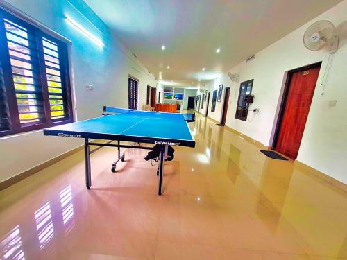 a ping pong table in the middle of a room at Green Aura By BOB in Sultan Bathery