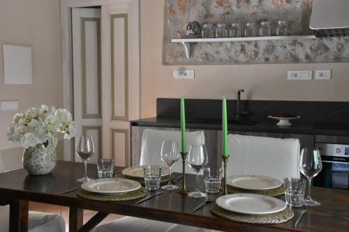a dining room table with plates and wine glasses at La Vecchia Scuola in Stifone