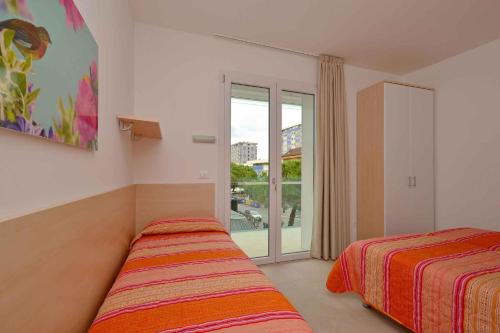 Ένα ή περισσότερα κρεβάτια σε δωμάτιο στο Apartments in Lignano 21708