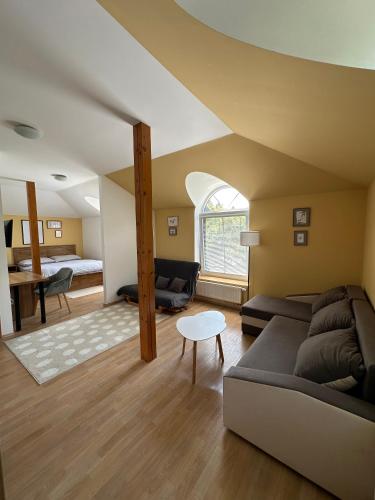 a living room with a couch and a bed at penzion LILIE in Litomyšl