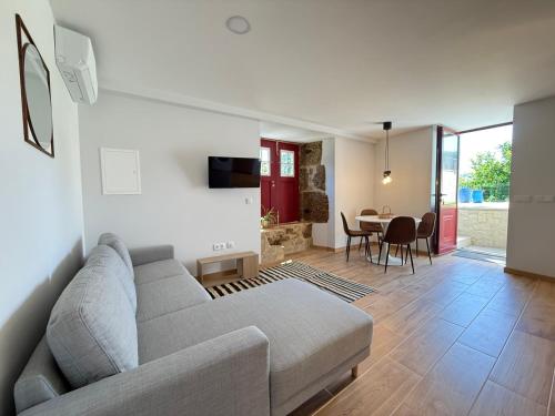 a living room with a couch and a table at Refúgio Rural - Gerês in Terras de Bouro