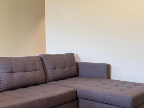 a brown couch sitting in a living room at Refúgio Rural - Gerês in Terras de Bouro