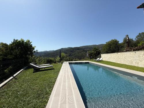 a swimming pool in the yard of a house at Refúgio Rural - Gerês in Terras de Bouro