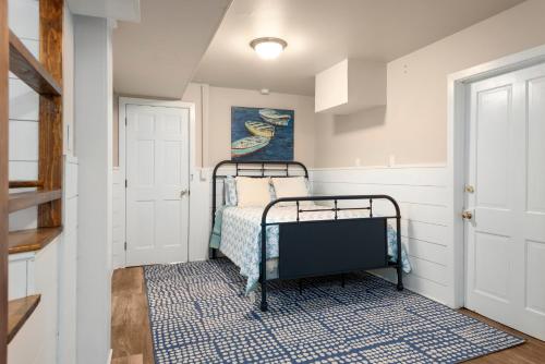 a small bedroom with a bed and a blue rug at Its Beach Time in Nags Head