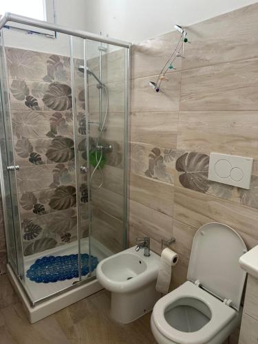 a bathroom with a shower and a toilet and a sink at Villa Bludea - Salento in Torre Lapillo