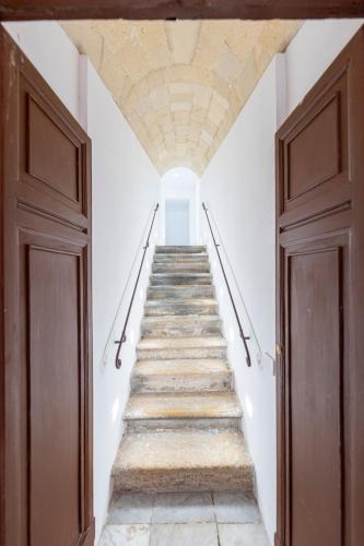 a staircase in a building with a stone ceiling at Alberti Apartments in Trapani