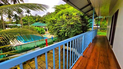 a balcony with a view of a swimming pool at BOB Green Aura in Sultan Bathery