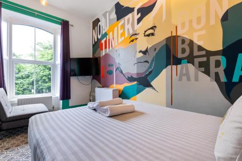 a bedroom with a bed with a painting on the wall at 44 North in Londonderry County Borough