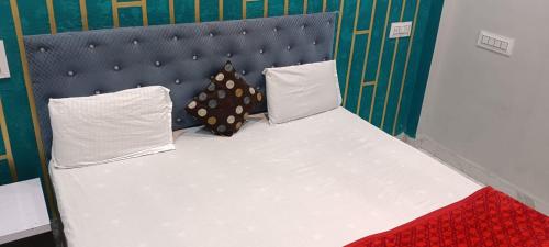 a bed with two pillows on it in a room at Hotel Shiv palace in Ujjain