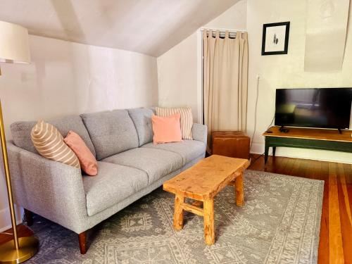a living room with a couch and a television at Cozy 1BD in Burlington’s Coolest Neighborhood in Burlington