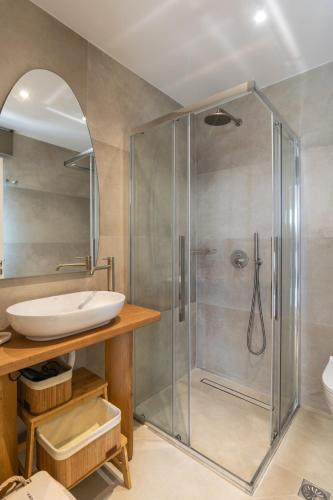 a bathroom with a shower and a sink at Ammos seafront house in Adamantas