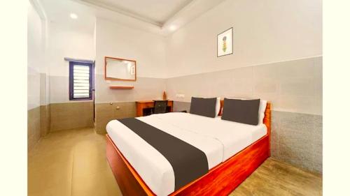 a bedroom with a large bed in a room at Wayanad West Residency in Kalpetta