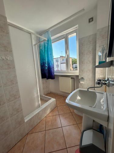 a bathroom with a tub and a sink and a shower at Willa Anna in Mielno