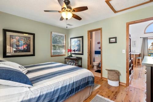 a bedroom with a bed and a ceiling fan at Kikis Retreat in Duck