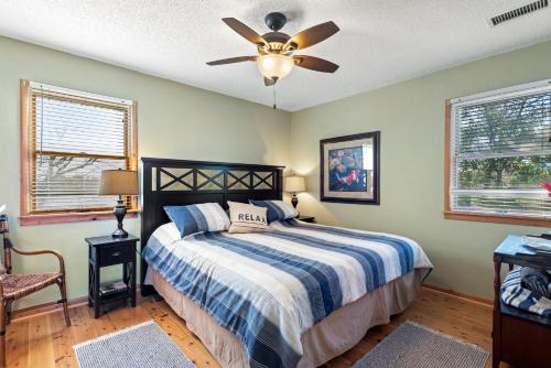 a bedroom with a bed and a ceiling fan at Kikis Retreat in Duck