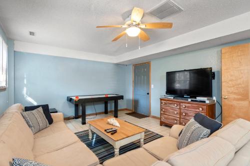 a living room with a couch and a flat screen tv at Kikis Retreat in Duck