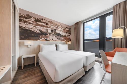 a hotel room with a white bed and a window at EXE Liberdade in Lisbon