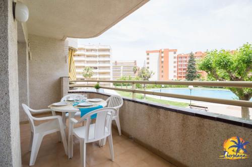 a balcony with a table and chairs and a pool at Cordoba IBERPLAYA in Salou