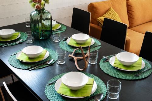 a black table with green plates and dishes on it at Rukan Hurmos in Ruka
