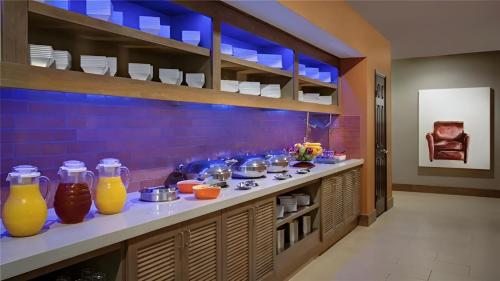a kitchen with a counter with bottles of orange juice at Hyatt House Dallas Uptown in Dallas
