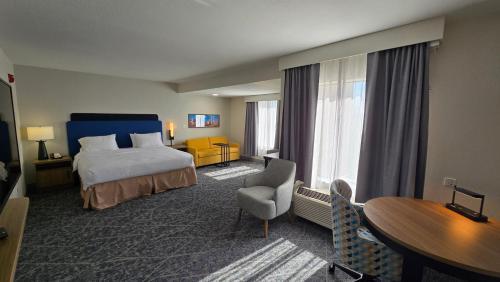 a hotel room with a bed and a table and chair at Hampton Inn & Suites Chicago Deer Park in Deer Park