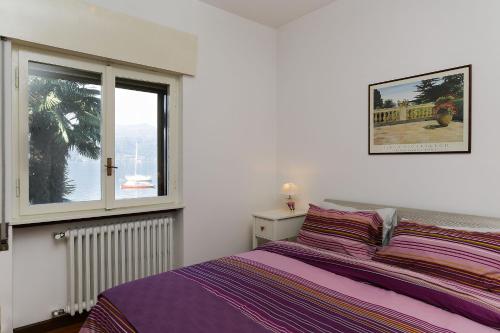 a bedroom with a purple bed and a window at Ranco Villa - 14006 in Ranco