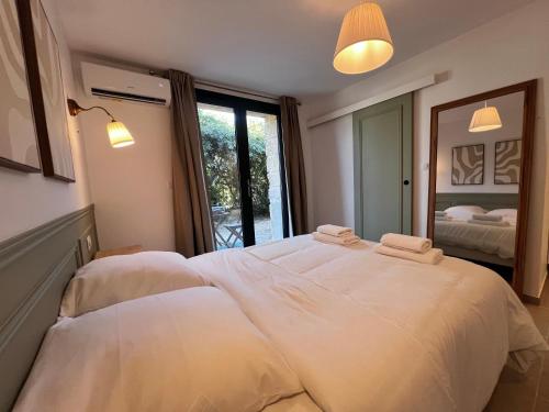 a bedroom with a large bed with two towels on it at Studio Avignon MONTFAVET in Avignon