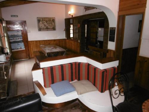 a living room with a couch and a coffee table at Hostel La Casa de Tounens in Puerto Madryn