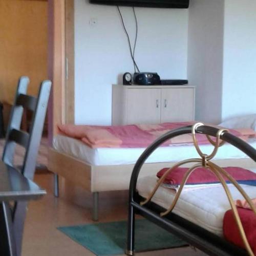 a bedroom with a bed and a chair in a room at NF Alpenvorland 