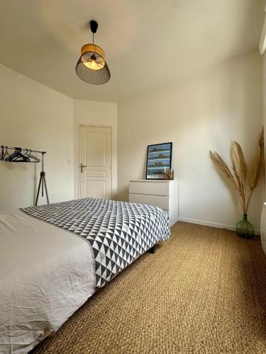 une chambre avec un lit et un ventilateur de plafond dans l'établissement Duplex 70m2 proche mer, 2 chambres, terrasse, parking gratuit dans la rue, à Saint-Malo