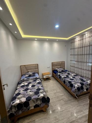 Ένα ή περισσότερα κρεβάτια σε δωμάτιο στο Beach Apartment in Ezzahra, Kelibia